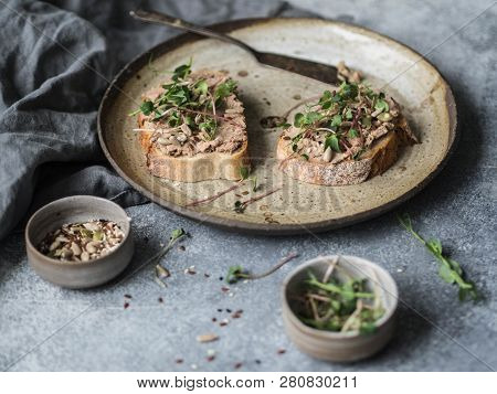 Two Toasts Duck With Prunes Rillettes Pate On White Bread With Sprouts And Various Seeds On A Vintag