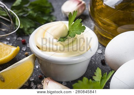 Mayonnaise Sauce And Ingredients On Black Stone Table. Close Up.
