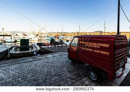 St. Tropez, France - 2019. Vintage Pizza Delivery Car Parked In The Habor Of St. Tropez, French Rivi