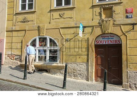 Prague, Czech Republic - May 2016: Old Man Walking On Sweet Old Street Near Beautiful Facade Of Trad