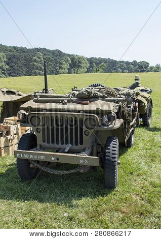Front View Of Wwii Jeep With Windscreen Down In Grass Field