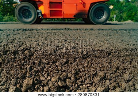 Vibratory Roller Compactor Is Laying A New Road Construction. Asphalt Paver Machine During Repairing