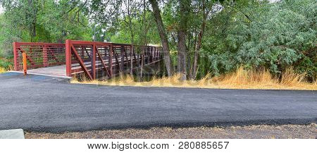 Views Of Jordan River Trail Pedestrian And Train Track Bridge With Surrounding Trees, Russian Olive,