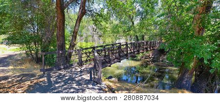Views Of Jordan River Trail Pedestrian And Train Track Bridge With Surrounding Trees, Russian Olive,