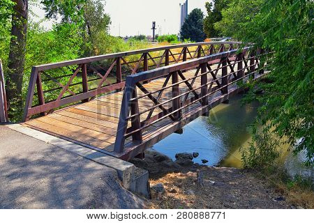 Views Of Jordan River Trail Pedestrian And Train Track Bridge With Surrounding Trees, Russian Olive,