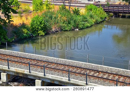 Views Of Jordan River Trail Pedestrian And Train Track Bridge With Surrounding Trees, Russian Olive,