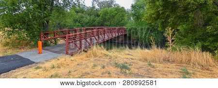 Views Of Jordan River Trail Pedestrian And Train Track Bridge With Surrounding Trees, Russian Olive,