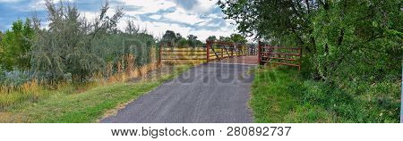 Views Of Jordan River Trail Pedestrian And Train Track Bridge With Surrounding Trees, Russian Olive,