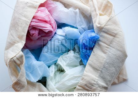 Multi-colored Blue, Red, White Plastic Bags In A Rag Cotton Bag On A White Background