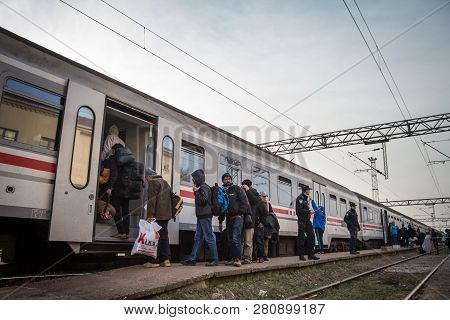 Sid, Serbia - November 14, 2015: Croatian Police Officers Checking Refugees, Boarding A Train To Cro
