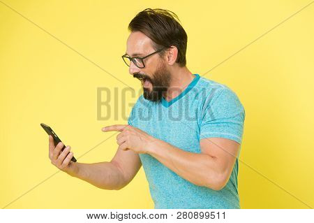Download Application. Hipster Cheerful Use Smartphone. Man Happy User Of Smartphone. Stay In Touch W