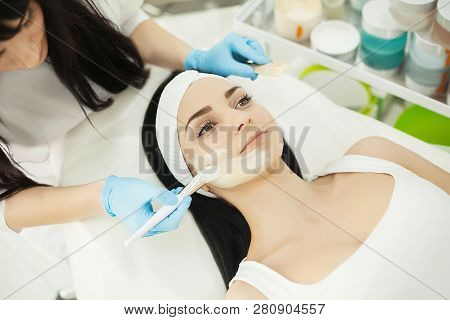 Girl At Spa Salon. Beautician Applying White Cosmetic Powder