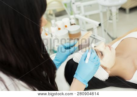 Girl At Spa Salon. Beautician Applying White Cosmetic Powder