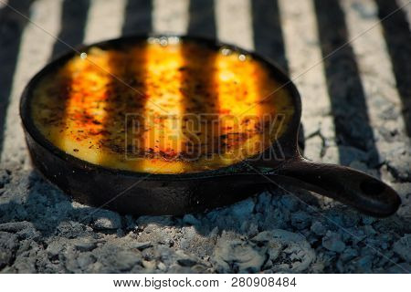 Delicious Argentinian Provolone Yarn Cheese (provoleta) That Is Cooked In A Cast Iron Skillet Over T