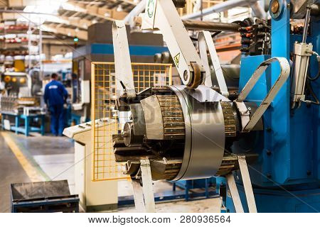 Cold Rolled Steel Coil On Decoiler Of Machine In Metalwork Manufacturing. Modern Equipment For Sheet