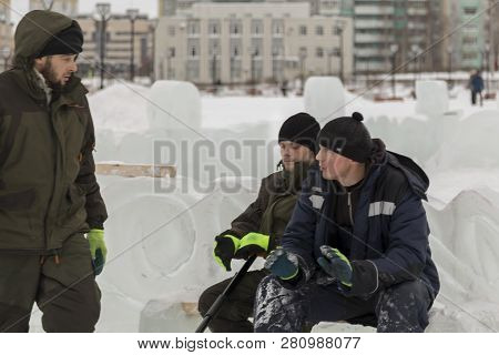 Three Workers At The Installation Of The Ice Town