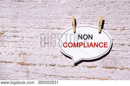 Non Compliance On A White Sheet With Wooden Pins