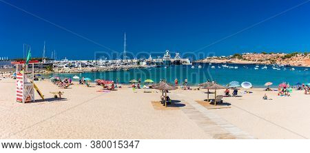 PORT ADRIANO, MALLORCA, SPAIN - 23 July 2020 - Tourists enjoying summer day on the popular city beach.