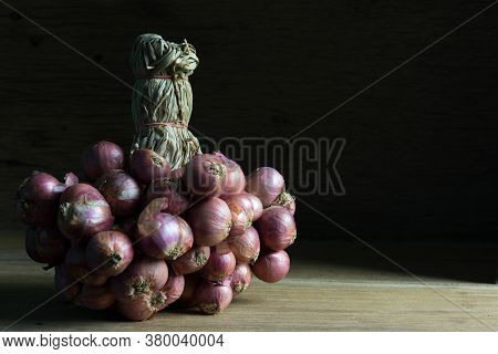 Bunch Of Onions On Wooden Tablel With Copy Space, Shadow Concept