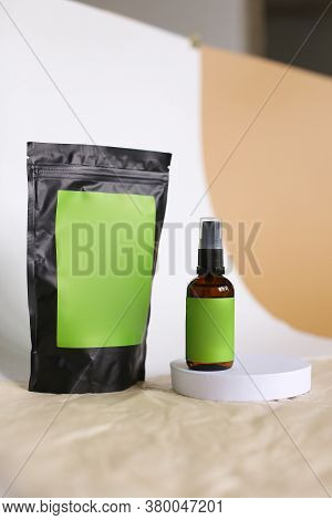 Close Up Doy Pack And Spray Bottle With Cosmetic Product, Green Space For Brand.