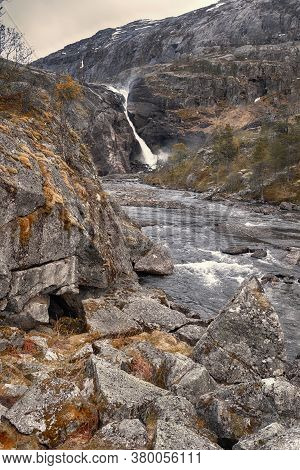 Norway Landscape, High Stone Plateau In The Mountains With Dried Grass In A Small River In The Natio