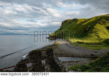 Scottish Landscape With Hills And Shoreline Near Staffin At Isle Of Skye With Ruins Of Old Diatomite