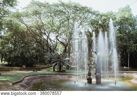 Fountain In The Park,cloud Blue Sky Reflection Near Urban Park With Walking Path In Suburban Irving