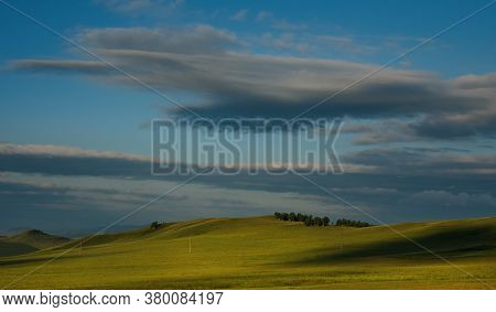Russia. Republic Of Khakasia. Endless Steppes Among Picturesque Hilly Mountains Near The Village Of 