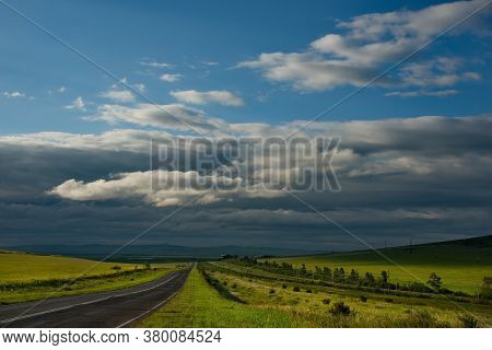 Russia. Republic Of Khakasia. Endless Steppes Among Picturesque Hilly Mountains Near The Village Of 