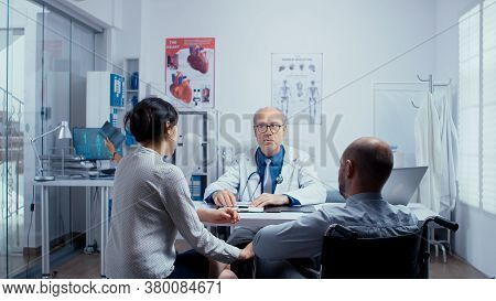 In Modern Clinic For Disabled And Handicapped Recovery, Young Man In Wheelchair Is Seeking Consultat