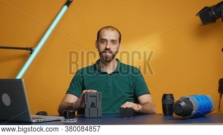 Videographer Recording Professional Review For Rechargeable Batteries. Modern V-lock Type Technology