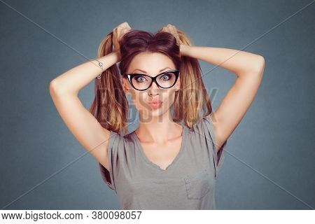 Beauty Woman Holding Hair In Two Ponytails Showing Grimace On Face Puckering Lips Blowing A Kiss Iso