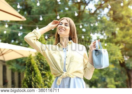 Beautiful Young Woman With Elegant Bag Outdoors On Summer Day