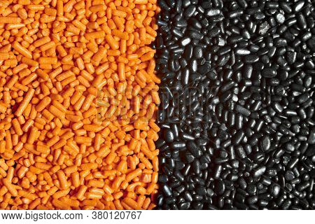 Orange And Black Unmixed Sprinkles Background, Halloween Theme, Textured Close-up Image