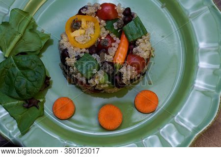 Closeup On Green Plate With Quinoa Salad Shaped As Small Cake On Wooden Table, - Quinoa Is A Pseudo-