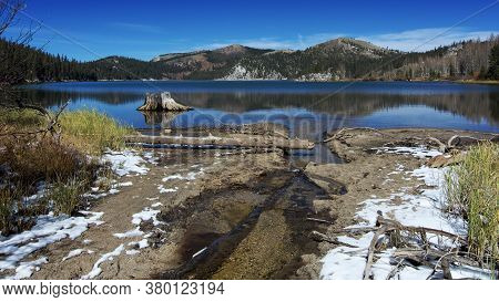 Overview Of The Marlette Lake In The Autumn, Highlighting Yellow Vegetation And First Snow On The Gr