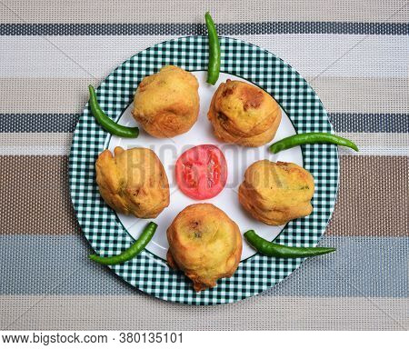 Mashed Potato Balls Coated With Chickpea Flour And Fried. Popular Street Food In India. Locally Call