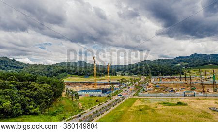 Aerial View Of Construction Site Under Ominous Clouds