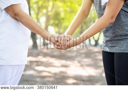 Woman Hands Holding To Elderly With Alzheimer Disease At Nature,adult Social Care Concept