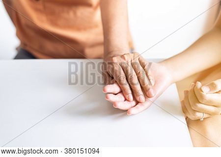 Woman Holding Hands To Elderly With Alzheimer Disease At Home,adult Social Care Concept