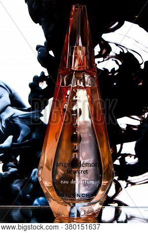 Zhytomyr, Ukraine - June 2, 2020. A Clear Orange Glass Spray Bottle Of Givenchy Ange Ou Demon Le Sec