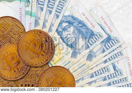 1000 Hungarian Forint Bills And Golden Bitcoins. Cryptocurrency Investment Concept. Crypto Mining Or
