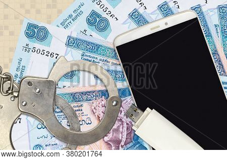 50 Sri Lankan Rupees Bills And Smartphone With Police Handcuffs. Concept Of Hackers Phishing Attacks