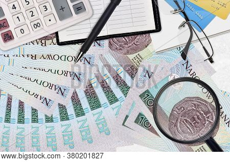 10 Polish Zloty Bills And Calculator With Glasses And Pen. Tax Payment Season Concept Or Investment 