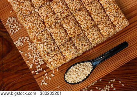 Honey Bars With Sesame Seeds Close-up On Wooden Background. Gozinaki Sweets. Traditional Oriental Co