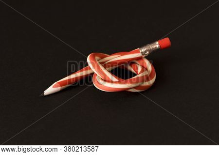 Flexible Pencil On A Dark Background. Selective Focus