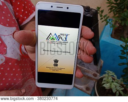 District Katni, India - May 23, 2020: Woman Holding Smart Phone With Displayed Atal Mission For Reju