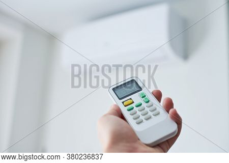 Remote Control For Air Conditioner In Hand. Room Condition Remote Control. Air Temperature Switch Fo