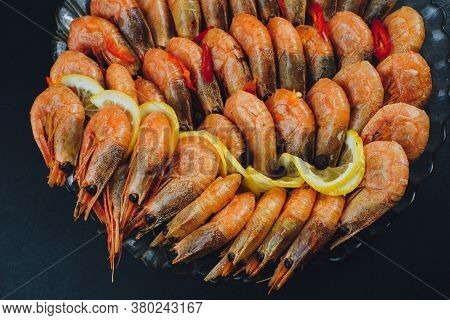 Shrimps With Lemon And Black Pepper On Dark Background Top View