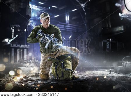 Army Soldier In Protective Combat Uniform Holding Special Operations Forces Combat Assault Rifle On 
